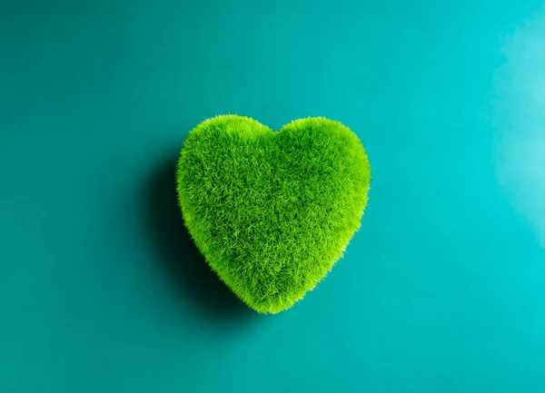 Green heart ball isolated on blue background. Green grass heart shape, green love. Environment and sustainable planet protection, Eco-friendly, love nature, world care, and Happy Earth Day concept.