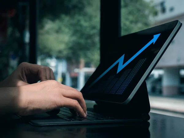 Digital investment analysis, trading, financial business growth concepts. Blue glowing arrow with grow graph on tablet computer screen using by business people trader who invest online stock market.
