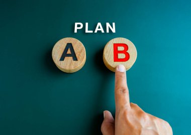 B planı, iş stratejisi ve karar kavramı. Plan, B planına işaret eden el üzerindeki metin, tahta bloktaki kırmızı alfabe, A 'nın yanında, mavi arka planda, minimal stil.