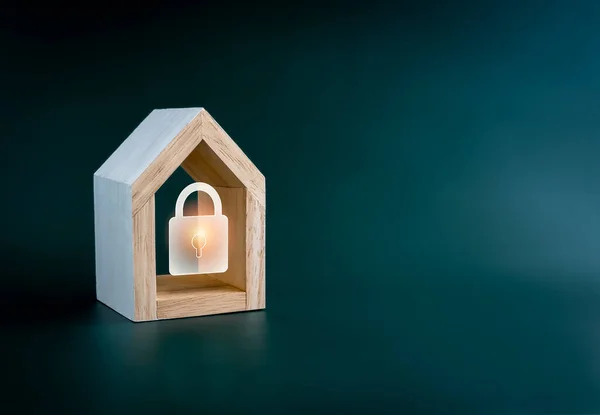 Digital lock icon glowing in simple miniature wooden house isolated on green background with copy space. Smart Home security, home insurance, real estate and property protection, home secure concept.