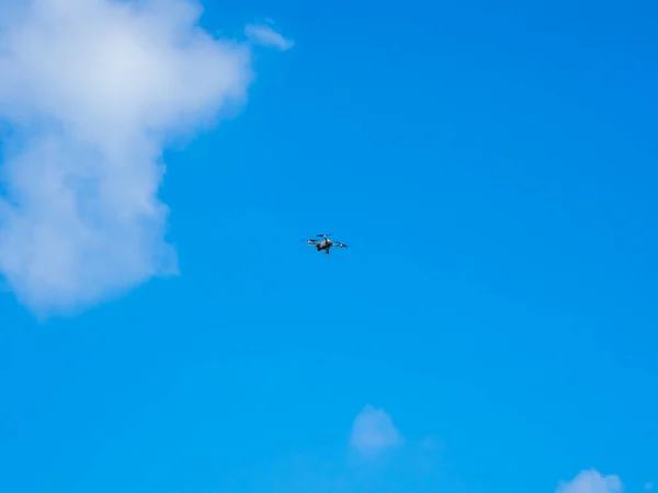 stock image Flying drone on blue sky background. The drone is being controlled to stay in the air.