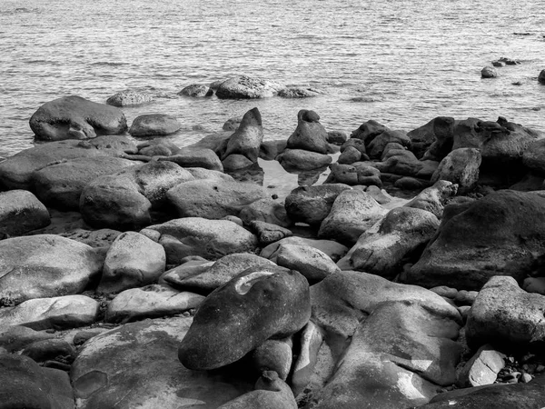 stock image Beautiful seascape view with rocks and water at the ocean background, dramatic nature. Black and white style of beach landscape with rock coast.