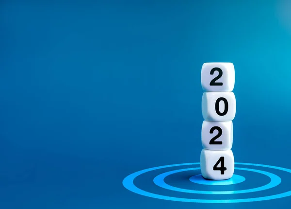 2024 Happy New year banner. 2024 year numbers on white dice cube blocks stacked on target dart icon on blue background with copy space. Start a growth business with goal and success concept.