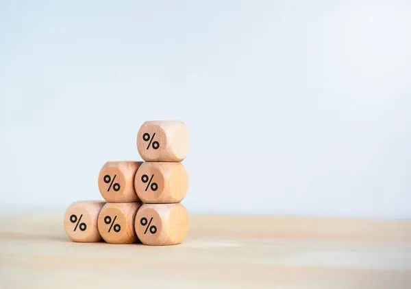 Percentage icon on wooden cube blocks as bar graph chart steps isolated on wood table and white background with copy space. Investment, income, trends, business growth, economic improvement concepts.