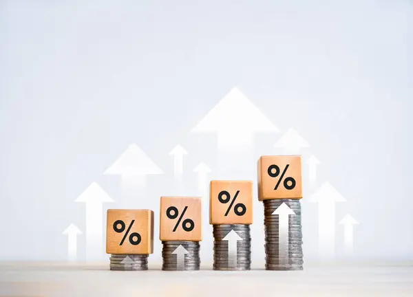 Percentage icon on wooden cube blocks on coin stacked bar graph chart steps with many up arrows on white background. Investment, profit, income, sales, business growth, economic improvement concepts.