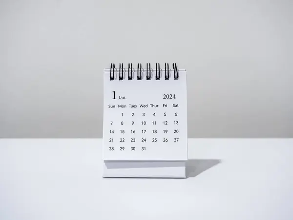 A January 2024 calendar desk for the organizer to plan and reminder isolated on white background, minimal style. White small table calendar with the page of the first month, Happy new year 2024.