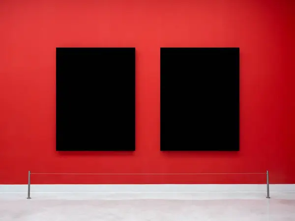 Mockup two blank space in black vertical square artist painting frames, isolated on red background. Empty 2 photo frames hanging on red wall behind display stanchions on white floor in museum.