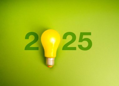 2025 new year innovative trend vision, eco-friendly concept. Green 2025 calendar year numbers with yellow creative idea light bulb isolated on light green color background, modern minimal, eco style.  clipart