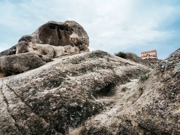 Uplistsikhe (The Lord 's Fortress), UNESCO' nun mağara şehrinin inanılmaz dünya mirası, doğa taşı ve yapısıyla antik kaya yontulmuş kasaba, mavi gökyüzü arka planı, Gürcistan 'daki ünlü seyahat cazibesi.