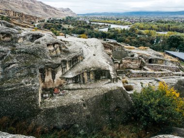Uplistsikhe (The Lord 's Fortress), inanılmaz UNESCO mağara şehrinin dünya mirası, mavi gökyüzü arka planında doğa taşı manzarası olan antik kaya yontulmuş kasaba, Georgia' da ünlü seyahat cazibesi.