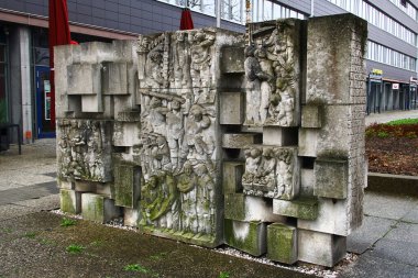 Chemnitz, Germany - March 23, 2024: The stele ensemble Lob des Lernens (Praise Poems), erected in 1972, based on verses by Bertolt Brecht, in which he pays homage to communism. clipart