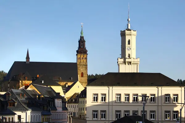 stock image Schneeberg, Germany - March 31, 2024: View of St. Wolfgang church and Town hall in Schneeberg, a historical mining town in the Ore Mountains, Saxony, Germany