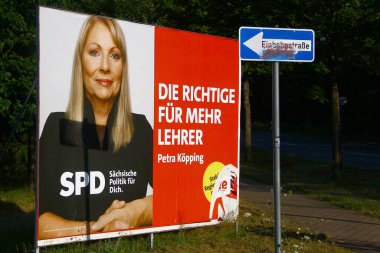 Oelsnitz, Germany - July 30, 2024: Pre-election poster of SPD Party candidate Petra Koepping, a German politician serving in the Saxon State Parliament clipart