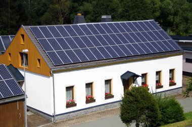 Solar panels on a roof of a private building clipart