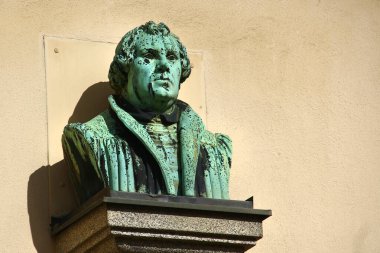 Markneukirchen, Germany - September 28, 2024: Bust of Martin Luther on St. Nicholas church in Markneukirchen, a town in the Vogtlandkreis district of Saxony. clipart