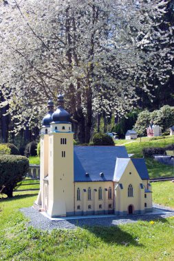 Adorf, Germany - May 8, 2023: Model of St.John church of Plauen in Klein Vogtland, a miniature park with detailed scale models of local landmarks, in Adorf, a town in the Vogtland region of Saxony. clipart