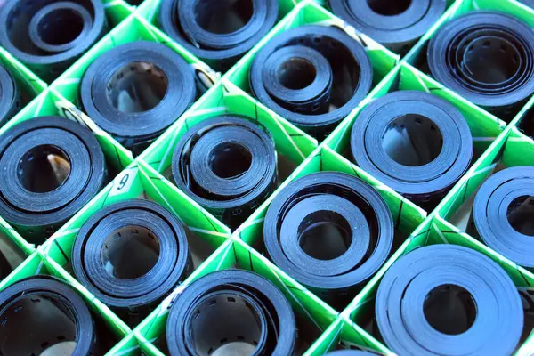 Yeşil ızgara konteynırında depolanmış rulo fotoğraf filmleri