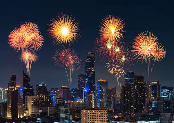 happy new year fireworks over buildings cityscape at night in Bangkok city, Thailand