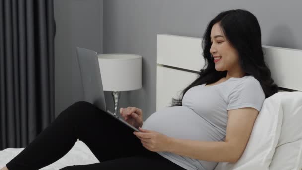 Έγκυος Γυναίκα Που Χρησιμοποιεί Φορητό Υπολογιστή Ένα Κρεβάτι — Αρχείο Βίντεο