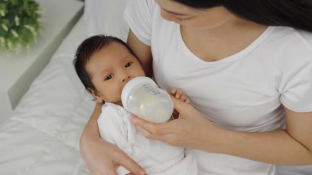 Mother Feeding Milk Bottle Her Newborn Baby Bed — Stock Video