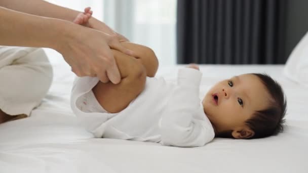 Руки Матери Держат Детские Ноги Делают Некоторые Игривые Упражнения Кровати — стоковое видео