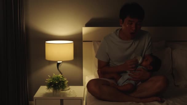 Álmos Fáradt Apa Tejesüveggel Eteti Újszülöttet Ágyon Éjszaka — Stock videók