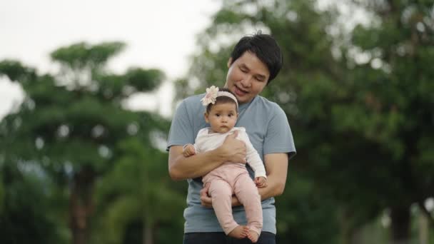 Father Holding Talking Infant Baby Park — Stockvideo