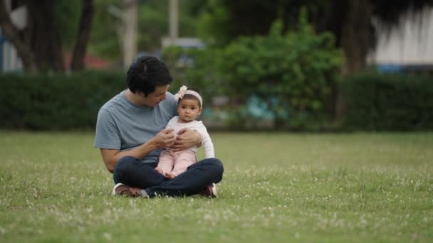 Father Talking Playing His Infant Baby While Sitting Grass Field — Video Stock