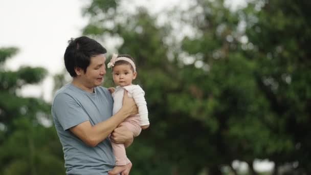 Father Holding Talking Infant Baby Park — Vídeo de Stock