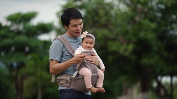 Father Talking Infant Baby Carrier Park — Vídeos de Stock