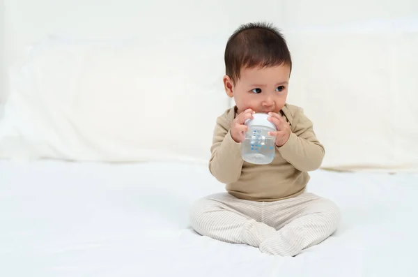 Baby Drinking Water Bottle Bed Stock Picture