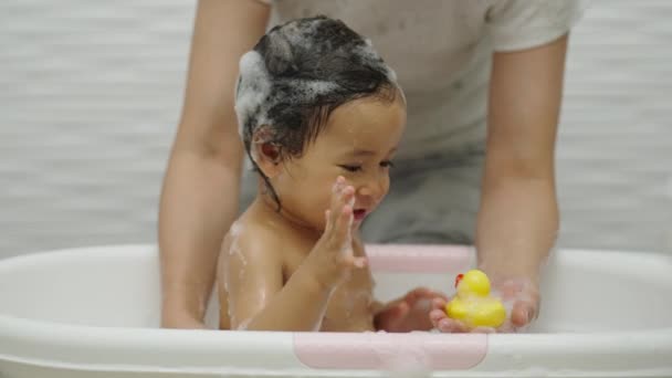 Mother Bathing Her Cheerful Infant Baby Foam Bubbles Playing Rubber — Stock Video