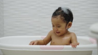 Mutlu bebek banyo yap ve evdeki küvette köpüklü ördek oyna.