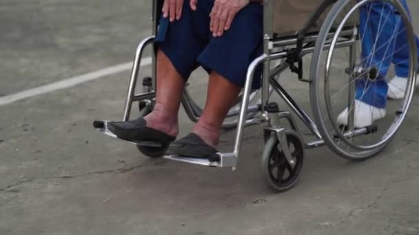 Close Feet Senior Woman Wheelchair Nurse Pushing Park — Stock Video