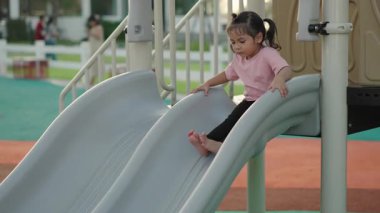 Yavru bebeğin açık havada kayıp oynaması ağır çekimde.