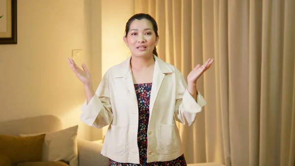 Young adult woman explaining and interview video online communication with casual clothing and speaking in room