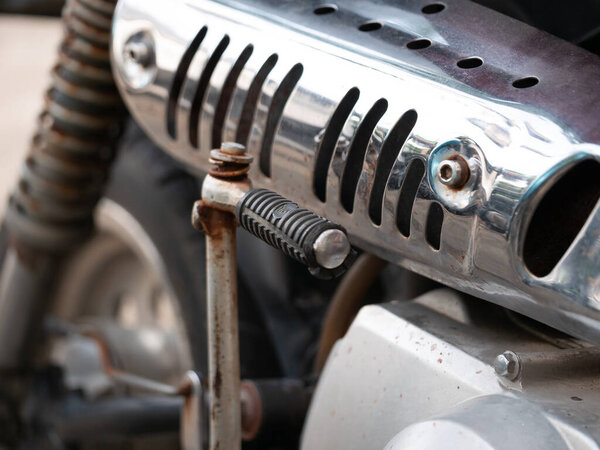 Motorcycle engine part close-up garage workshop mechanical component industrial environment macro viewpoint technical detail