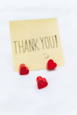 Business appreciation moment thank you note with hearts home office setting emotional gesture close-up shot gratitude concept clipart