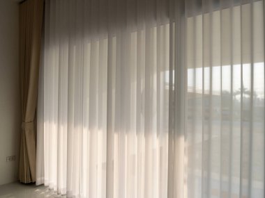 Modern oda iç tasarım sükunet atmosferindeki perdelerin arasından süzülen güneş ışığı.