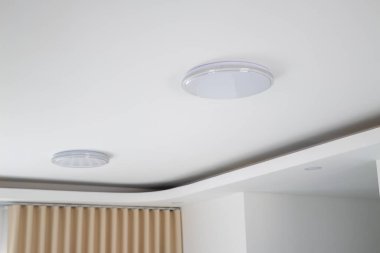 Explore the elegance of modern ceiling designs featuring LED lights in a contemporary home.