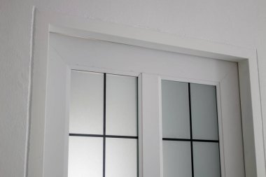 A sleek white door design showcases minimalist architecture with a modern touch.