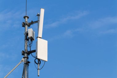 Telekomünikasyon kulesinin açık mavi gökyüzüne yakın görüntüsü modern bağlantıyı simgeliyor..