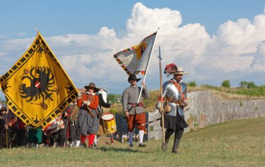 PALMANOVA, Italy - September 4, 2022: Reenactors parading after the battle during the Seventeenth Century annual historical reenactment clipart