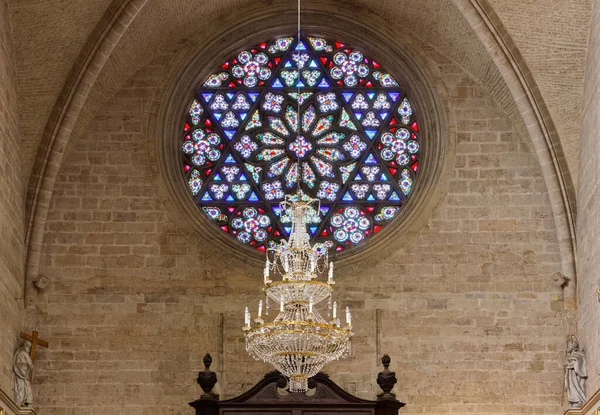 Big rose window and chandelier in the interiors of the Cathedral of Valencia, Spain