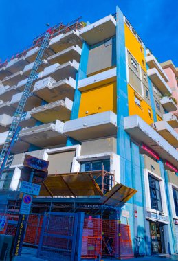 Bari, Italy - 10 January 2022: Scaffolding and protection nets on a condominium building affected by facade refurbishment works. Facade bonus tax deductions