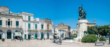 Rutigliano, Italy - 30 July 2022: Piazza XX Settembre with the Monument to the Fallen of World War I in the historic centre of Rutigliano, a municipality in the province of Bari Puglia.