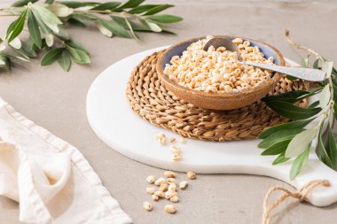 Puffed wheat in ceramic bowl. Cereal breakfast on kitchen table. Kitchen countertop. Cooking Healthy Food.