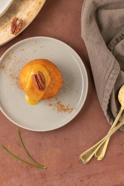 Rabanada 's poveiras with egg cream and cinnamon and pecan nuts on a rustic kitchen counter during the Christmas season.