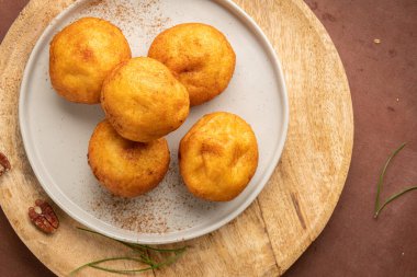 Rabanada 's poveiras with egg cream and cinnamon and pecan nuts on a rustic kitchen counter during the Christmas season.