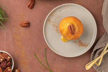 Rabanada 's poveiras with egg cream and cinnamon and pecan nuts on a rustic kitchen counter during the Christmas season.